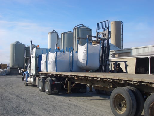 Bulk bags being loaded by forklift for transport via truck